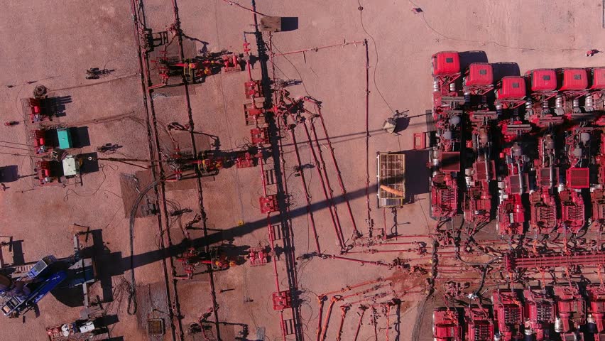 A drone takes panning of a fracking site in Vaca Muerta, Argentina. Trucks with ultra-high-pressure engines break up the rock to extract gas and oil.