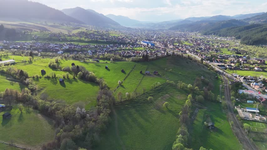 Sunset light over Campulung with blossom trees and buildings