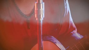 Man singing into retro microphone on music stage amid red haze, overlaying animated wave charts. Performance, vocalist, ambiance, passion, artistry, stage, emotion - Powered by Shutterstock - Get 15% off with code: PIKWIZARD15