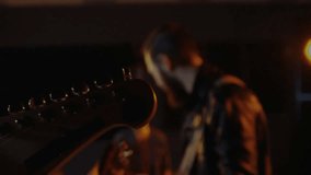 Guitarist hand strumming acoustic guitar in dim music studio, displaying animated GOOD VIBES text. Musician, harmony, atmosphere, tranquility, intimacy, melody, energy - Powered by Shutterstock - Get 15% off with code: PIKWIZARD15