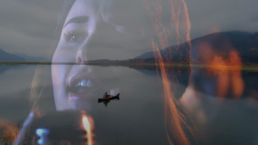 Travel scene showing man paddling red canoe on mountain lake at dusk, blending warm flame overlays. Adventure, tranquility, landscape, reflection, surreal, dusk, wilderness