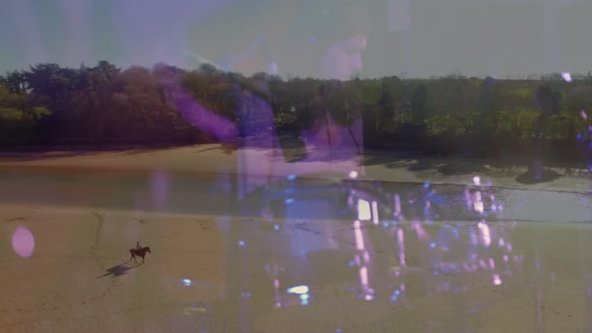 male rider traveling sandy beach, with purple grid and hand shapes representing technology. Adventure, solitude, wilderness, natural, contemplative, scenic, artistic