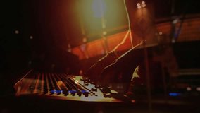 Music producer adjusting console knobs under spotlight, LED lights with animated waveform overlay. Audio, control, stage, technology, performance, equipment, ambiance - Powered by Shutterstock - Get 15% off with code: PIKWIZARD15