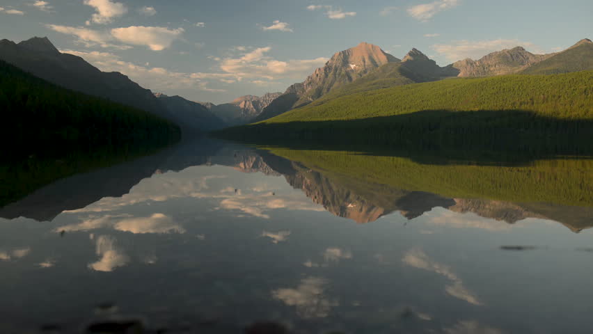 Insects Fly Over and Clouds Reflect in Bowman Lake in Glacier National Park