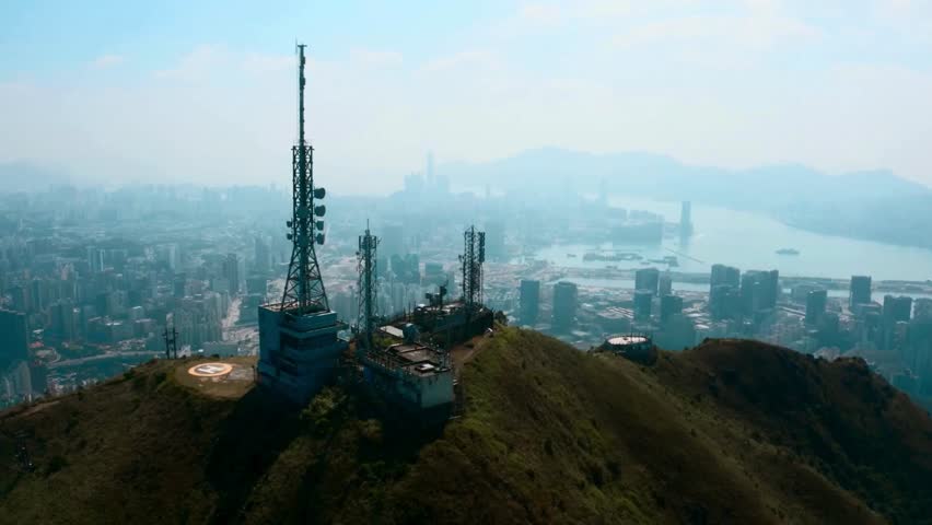 Urban Skyline View with Communication Towers on Hilltop