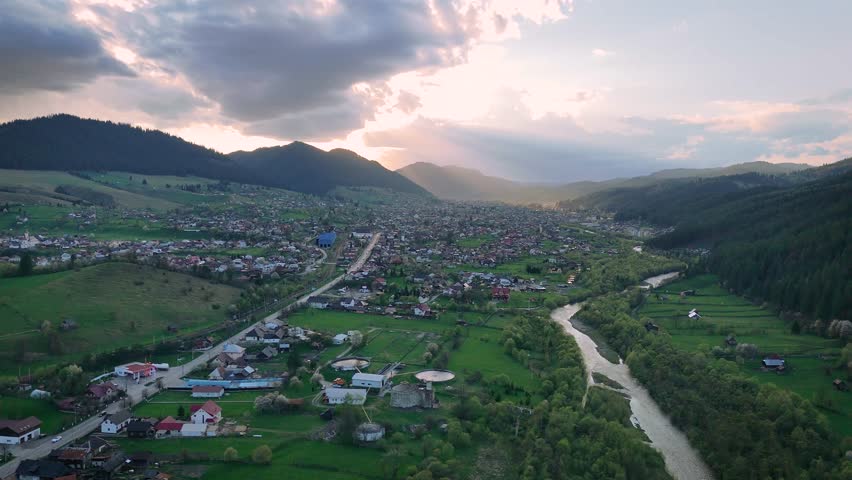 Drone aerial video of sunset over Campulung city and Moldova river