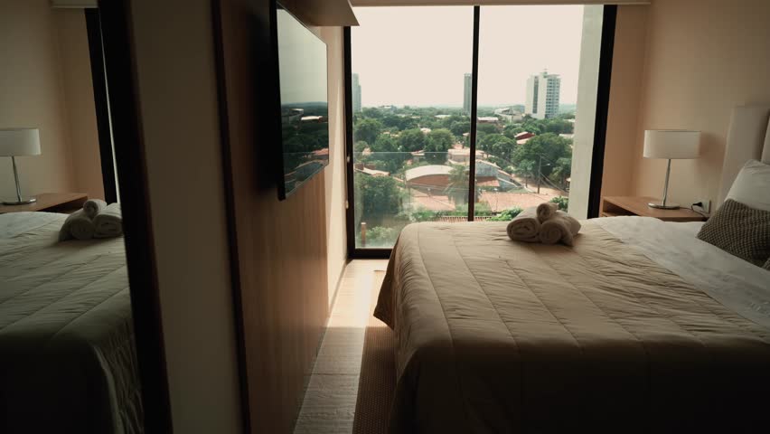 Cozy Bedroom with City View of Asunción, Paraguay from a Large Window