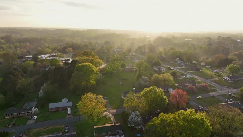 Dreamy serene atmosphere with colored trees during golden Sunset in Virginia, USA. Housing area and neighborhood in small quiet town and sun rays in USA. Beautiful scenic lush area in Virginia.