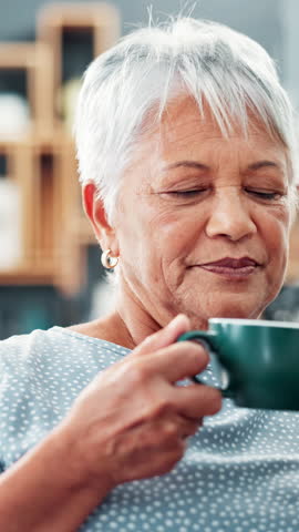 Senior woman, coffee and smell in home, morning and relax for reflection with memory in living room. Elderly person, mug or smile with scent, tea cup and steam in lounge for retirement in apartment