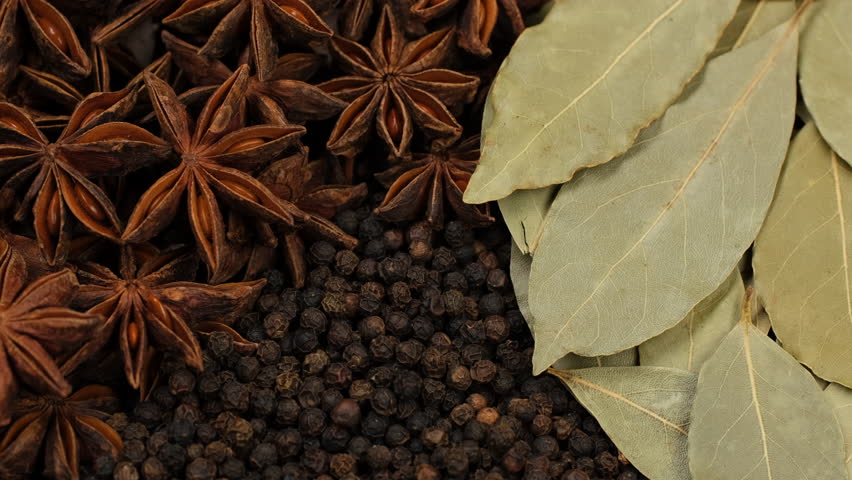 Mixed spice star anise, black pepper, bay leaf in plate, rotate