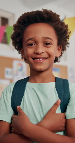 Face, smile and kid in school for learning, education or youth development. Portrait, happy boy and confident child in class with arms crossed for growth, scholarship or African student in elementary