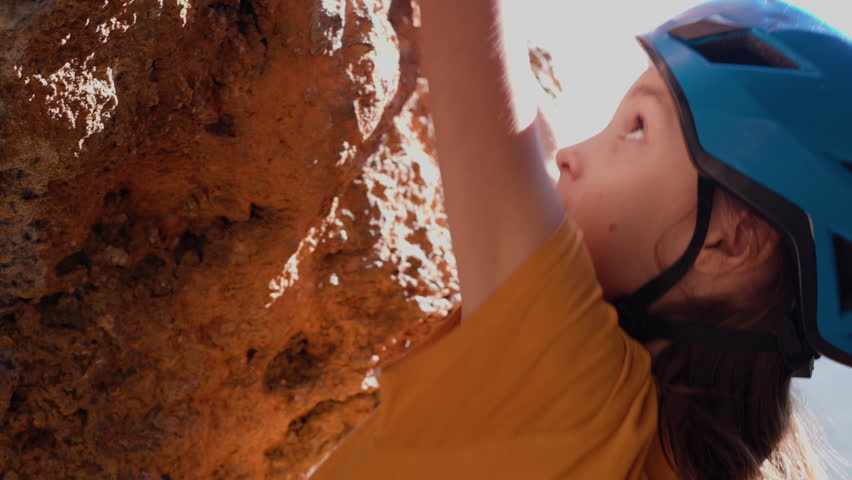 Summer camp. Outdoor sports. Boy rock climber. Child rock climbing. Cute teenager climbing rock with safety rope, sporty people lifestyle concept
