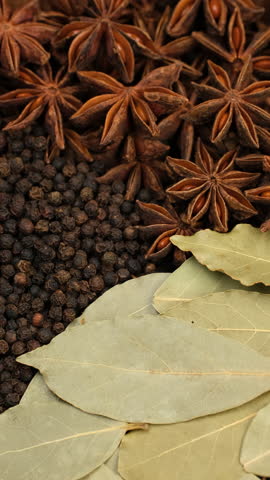 Different spice star anise, black pepper, bay leaf in plate, rotation