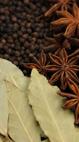 Mixed spice star anise, black pepper, bay leaf in plate, rotate