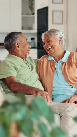 Senior couple, laugh and talking on sofa with funny memory, love and bonding with care in living room. Elderly people, man and woman on couch with comic conversation, joke and nostalgia in retirement
