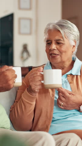 Coffee, relax and senior couple on sofa with warm drink for bonding, marriage and wellness in home. Retirement, living room and mature man and woman with beverage for conversation, talking and chat