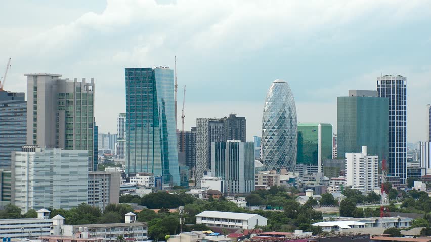 BANGKOK, THAILAND - AUGUST 2024 : View of tall office buildings at business district in Bangkok. Economical growth, finance and development concept video.