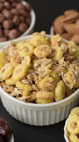 Flakes, chocolate balls and dried fruit for a hearty breakfast. Granola with chocolate flakes