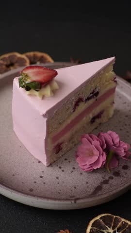 A slice of pink colored puff cake for a birthday celebration. Sweets to celebrate a wedding or valentine