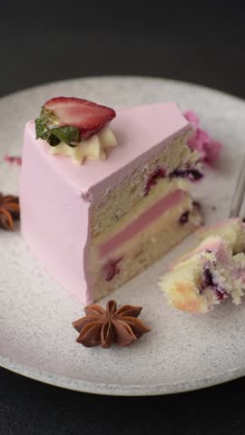 A slice of pink colored puff cake for a birthday celebration. Sweets to celebrate a wedding or valentine