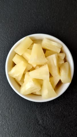 Tropical sweet tinned pineapple fruit sliced into slices. Pineapple as an ingredient for pizza or salad