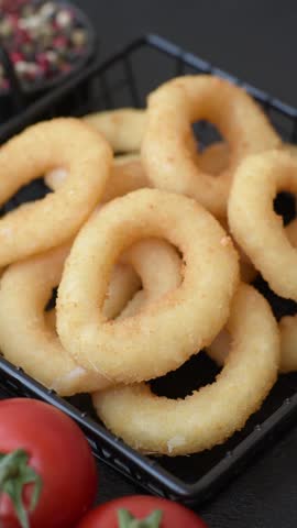 Onion rings or squid rings fries crispy, savory with sauce. Fast food, restaurant, junk food