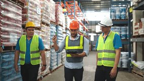 Three warehouse workers engage in a collaborative discussion about safety procedures and inventory management, using digital devices to enhance productivity. - Powered by Shutterstock - Get 15% off with code: PIKWIZARD15
