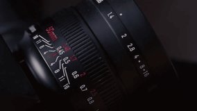 Close up: film photography lens shifts focus. Moving distance scale on vintage film photography lens during focusing. Fingers adjusting DSLR Lens - Powered by Shutterstock - Get 15% off with code: PIKWIZARD15