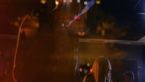 bandmates playing keyboard outdoors under spotlights, using mic with floating technology icons. Live performance, nightlife, stage lighting, music ensemble, urban, artistic, vibrant - Powered by Shutterstock - Get 15% off with code: PIKWIZARD15