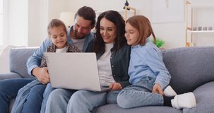 Happy young family at home with laptop online, parents, little kids on sofa in kitchen have fun using modern new computer together, enjoy weekend with small children, watch video, make order  - Powered by Shutterstock - Get 15% off with code: PIKWIZARD15