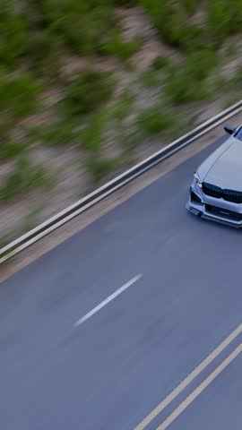 drone view of silver car driving on the road
