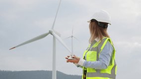 A female engineer in safety gear studies a miniature wind turbine model, demonstrating innovative thinking in renewable energy. The scene highlights sustainability and modern engineering. - Powered by Shutterstock - Get 15% off with code: PIKWIZARD15