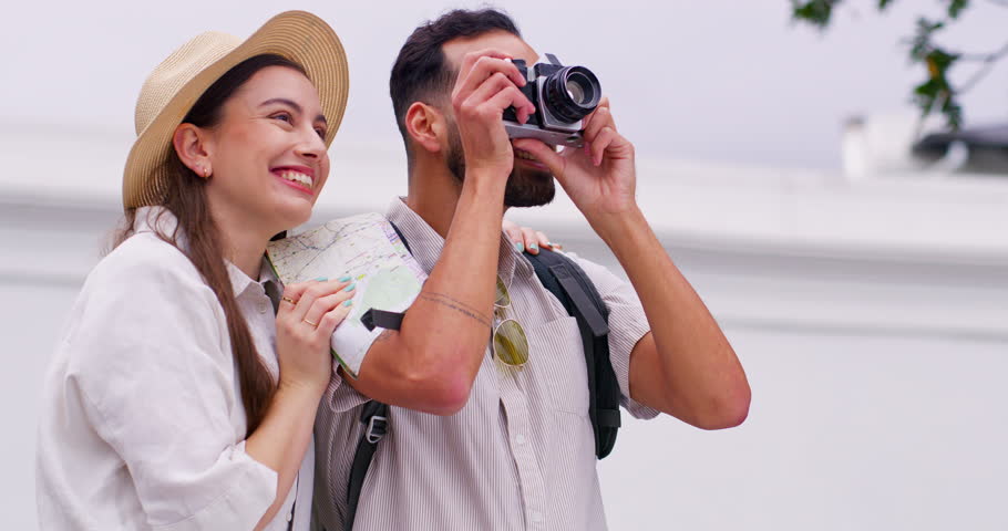 Photographer, couple and camera for vacation, holiday or journey with city, street or town sightseeing. Tourist travel, man and woman with pictures for memory, social media and adventure together