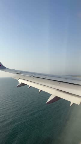 The plane landing in the city of Larnaca, Cyprus, view from cabin, vertical