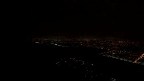 Spectacular drone footage capturing the night view of Islamabad and the Margalla Hills during a rainy thunderstorm. The sky flashes with powerful lightning, while the city lights glow beneath a moody, - Powered by Shutterstock - Get 15% off with code: PIKWIZARD15