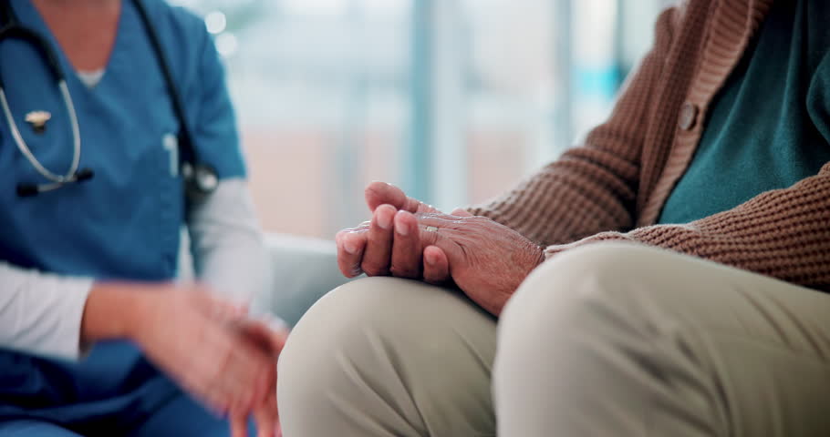 Comfort, empathy or holding hands with nurse and patient in retirement home for assisted living or support. Consulting, healthcare or medical with caregiver and old person closeup in apartment