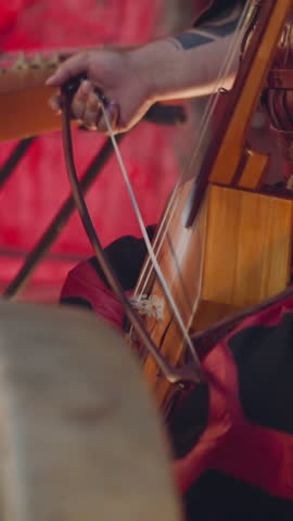 Musician performs playing igil bow instrument at tribal concerts on stage closeup. Traditions of Altai music. Meditative sound and inspiring show