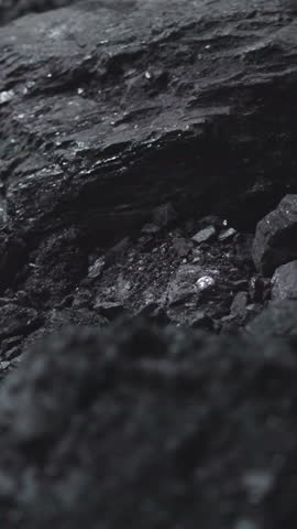 Textured charcoal pile in power generating station storage closeup. Fossil fuel extraction for industrial purposes. Burning rock deposits at plant
