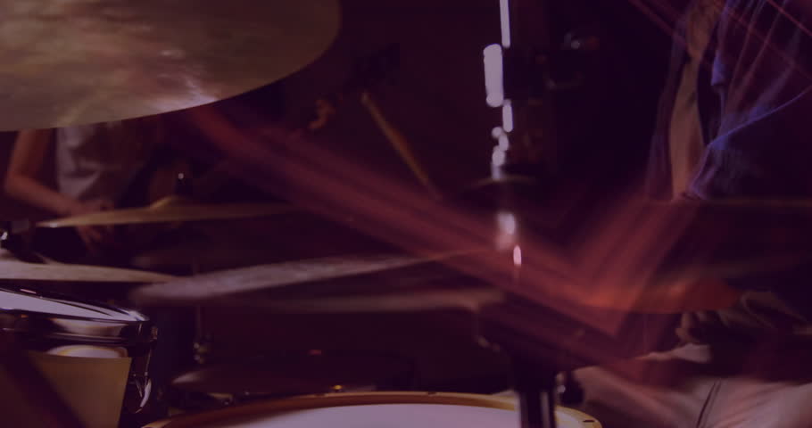 Drum cymbal getting highlighted in animated close-up, showing mounting clamp under warm red lights. Percussion, performance, stage, lighting, intensity, motion, musical