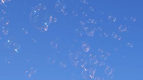 Soap bubbles rise towards a clear blue sky, creating a whimsical and dreamy atmosphere. Ideal for backgrounds, overlays, and joyful projects. - Powered by Shutterstock - Get 15% off with code: PIKWIZARD15