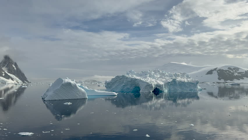 Big Iceberg in Antarctica Winter Scenery, Amazing Shape Ice Formation of Massive Large Enormous Blue Icebergs in Antarctic Peninsula Landscape Seascape with Ocean Sea Water