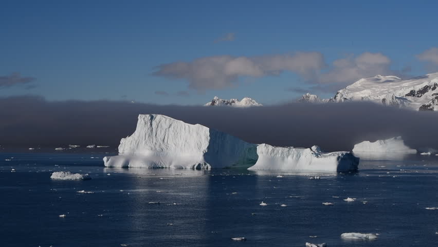 Big Iceberg in Antarctica Winter Scenery, Amazing Shape Ice Formation of Massive Large Enormous Blue Icebergs in Antarctic Peninsula Landscape Seascape with Ocean Sea Water