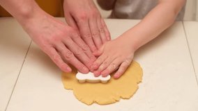 Child hands cutting cookie dough with plastic cutter on white table. Close-up baking and cooking concept. Family cooking and homemade bakery. Kid aged three years (3 year old boy) - Powered by Shutterstock - Get 15% off with code: PIKWIZARD15