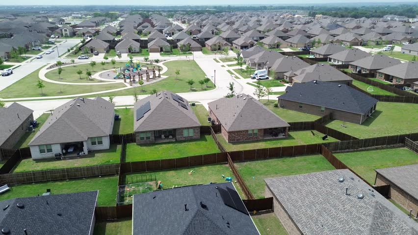 Flyover new construction two story houses with solar roofing and children playground park in Princeton suburbs Dallas metroplex, upscale suburban homes in fast growing Collin County, North Texas. USA