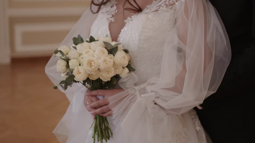 Very beautiful wedding bridal bouquet, made of white roch and austoma, and yellow daisies, green casting of eucalyptus.  Wedding, engagement. Bride and groom. Bride's wedding bouquet.