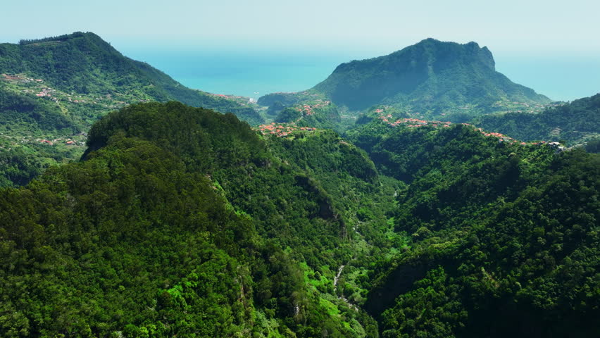 Small town on Madeira island, Coastline Village in the Mountains, Green Forest with Fog At Summer Season