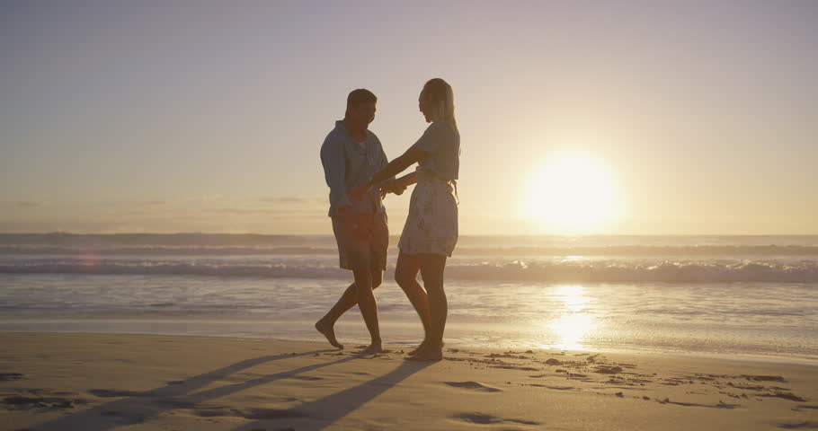 Beach, sunset and couple holding hands for proposal for romance, love and commitment offer. Engagement, holiday vacation or man on knee to ask woman question on valentines day or anniversary date