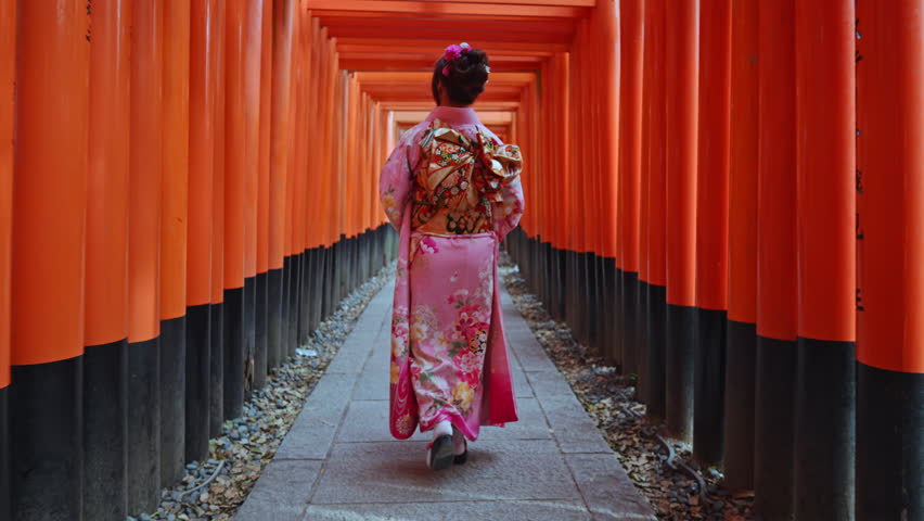 4k Slow motion video, Asian woman in traditional Japanese kimono at Fushimi Inari Shrine in Kyoto Japan.