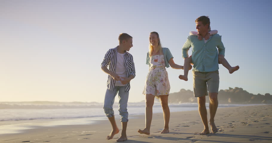 Parents, talking or kids at beach walking at sunset for holiday or travel with boy, girl or family. Siblings, mom or dad with children at sea on vacation together for wellness, joy or nature to relax
