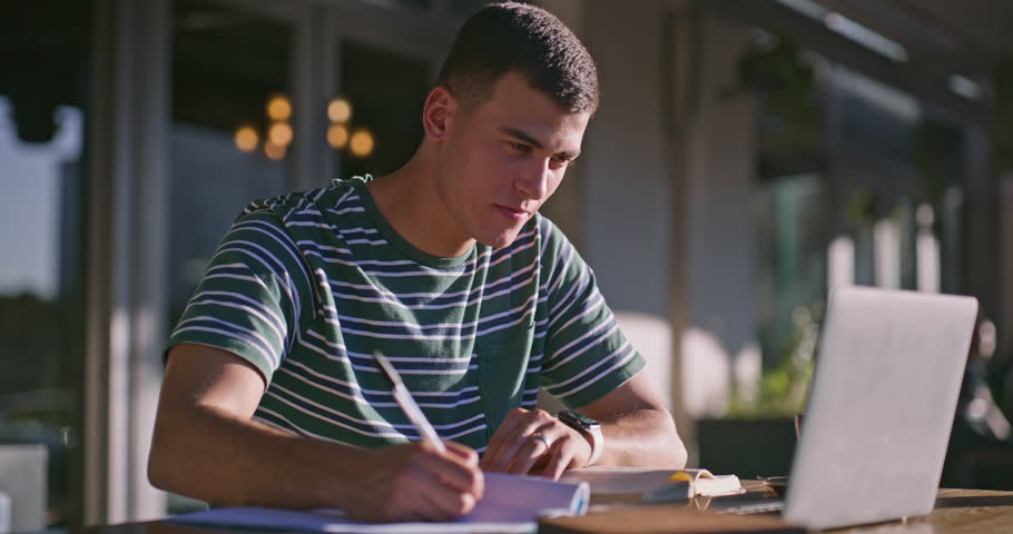 Man, face and college student with laptop outdoor for writing notes, learning or assignment. Happy, campus and portrait of male person studying with computer for university admission test in London